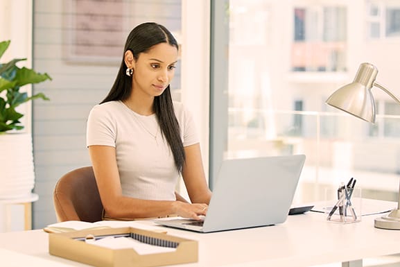 Focused and ready to tackle this day. Shot of a young project manager working on laptop